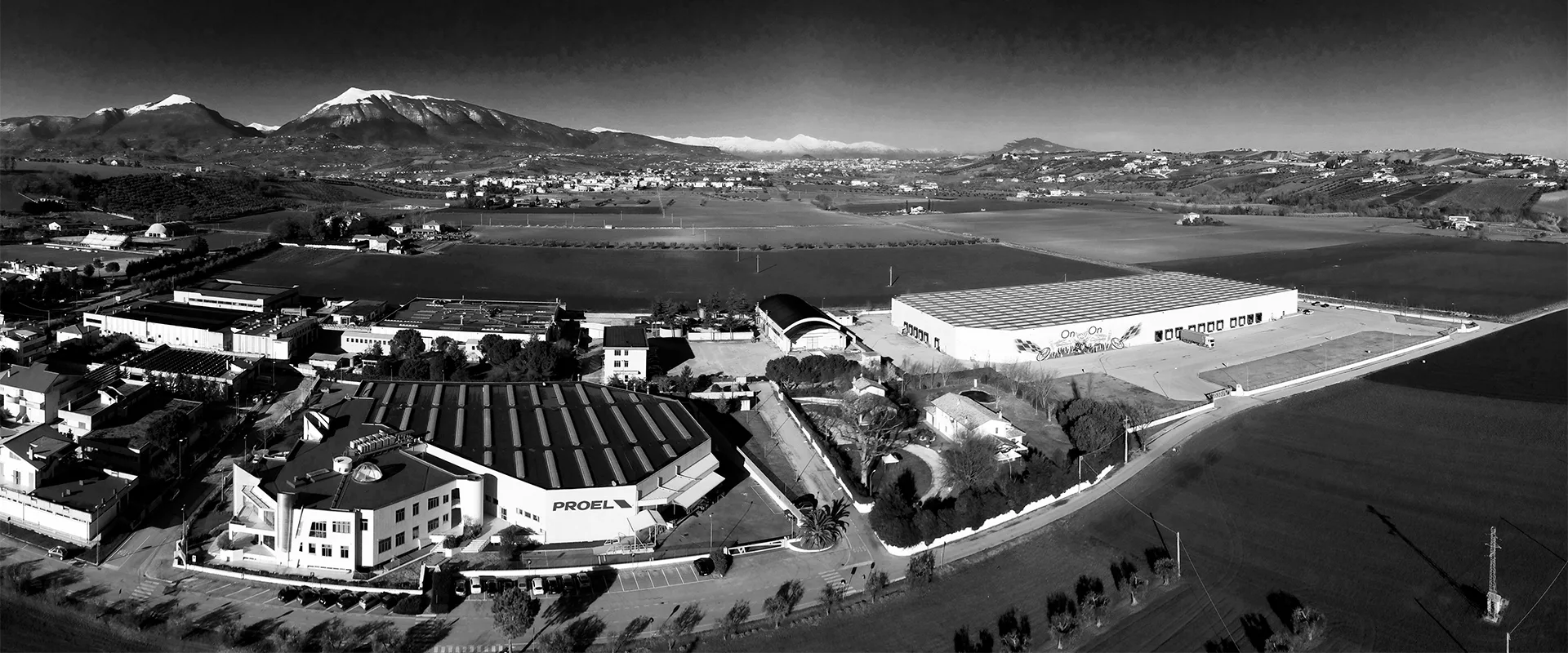Aerial view of the PROEL headquarters in Sant'Omero, with the Gran Sasso range behind